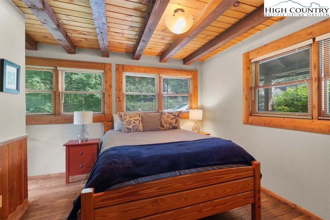 117 Chinkapin Ridge Road Seven Devils, NC 28604 - Photo 16 of 43 a bedroom with a bed and wooden floor