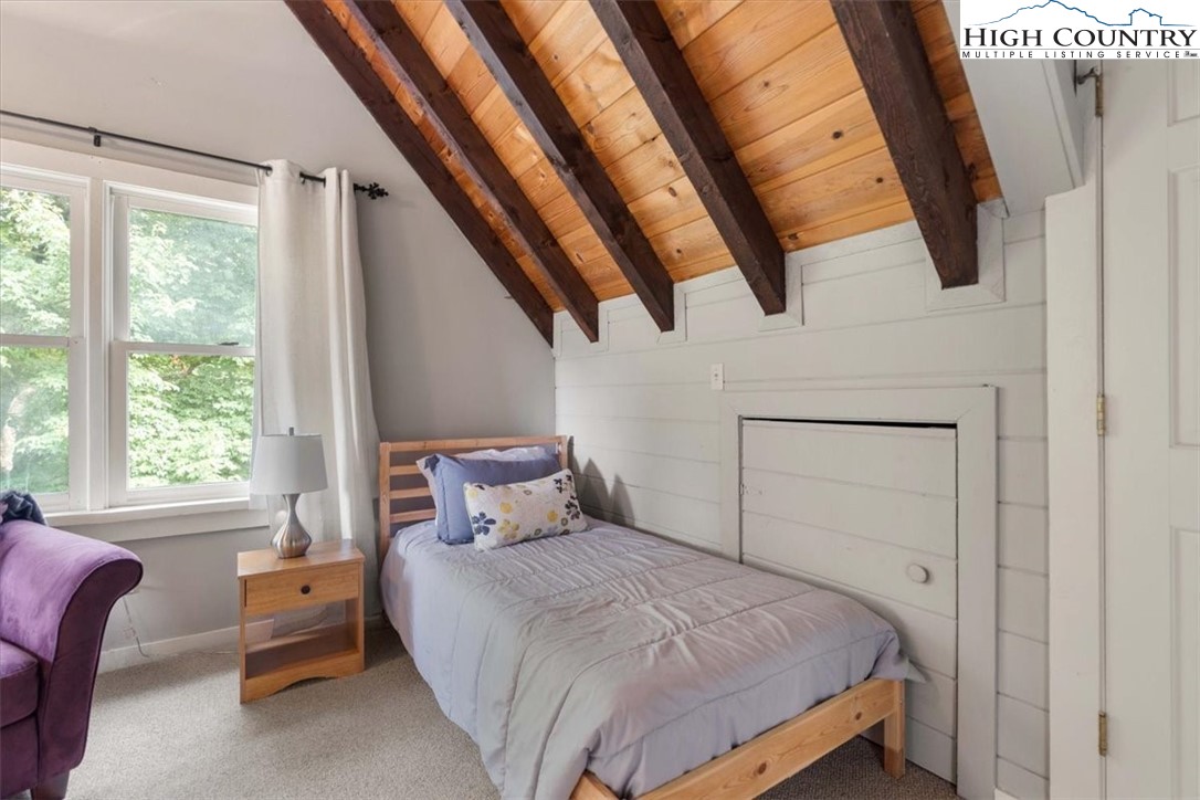 117 Chinkapin Ridge Road Seven Devils, NC 28604 - Photo 17 of 43 a bedroom with a bed and a large window