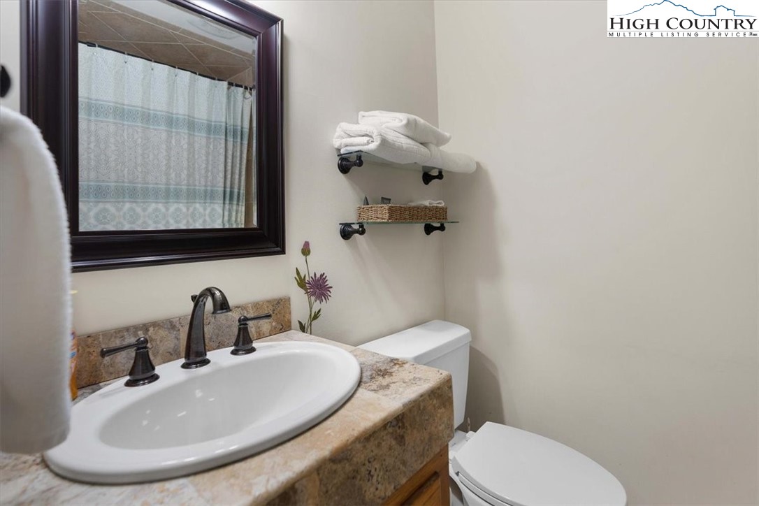 117 Chinkapin Ridge Road Seven Devils, NC 28604 - Photo 18 of 43 a bathroom with a toilet sink and mirror