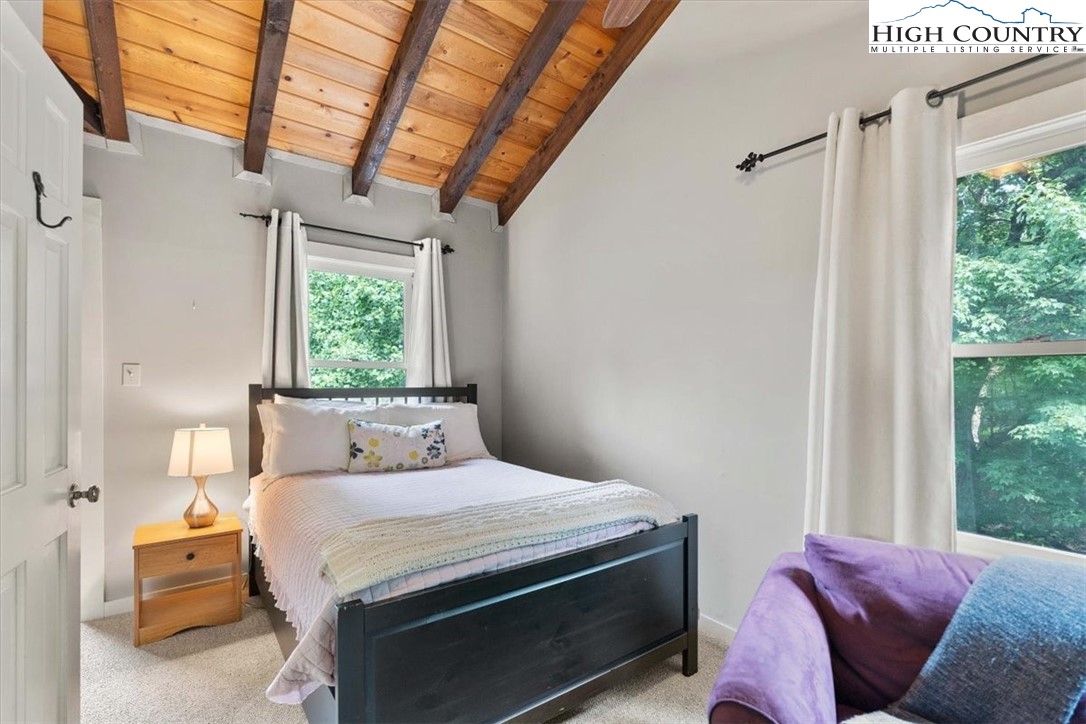 117 Chinkapin Ridge Road Seven Devils, NC 28604 - Photo 19 of 43 a bedroom with a bed couch and window