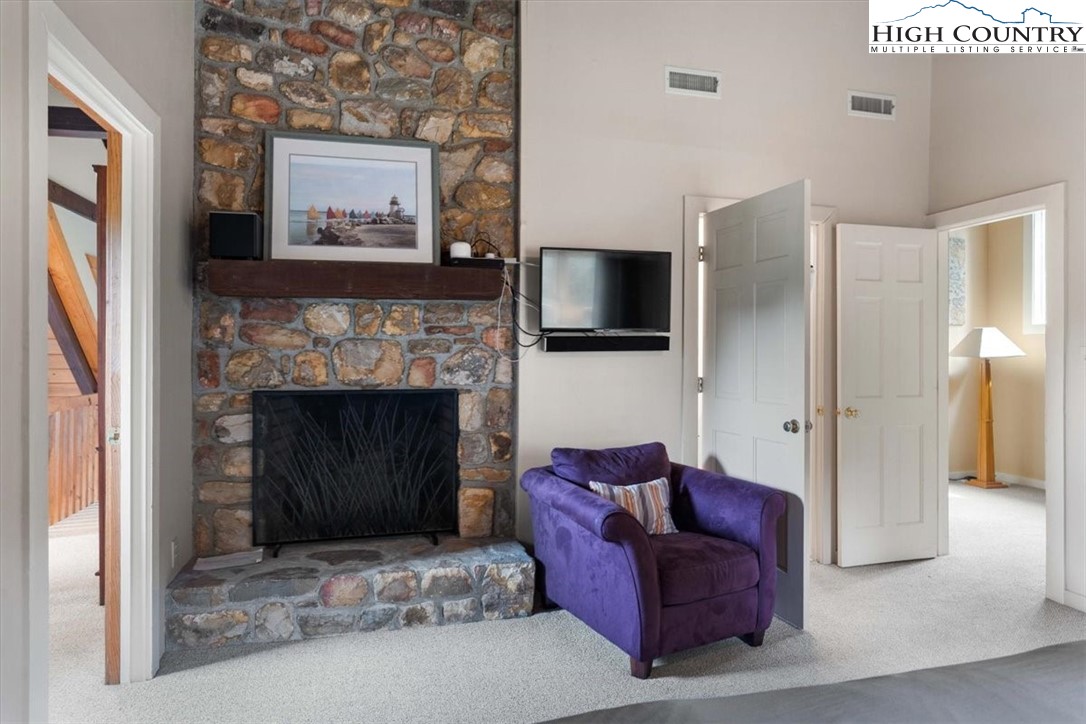 117 Chinkapin Ridge Road Seven Devils, NC 28604 - Photo 21 of 43 a living room with furniture and a fireplace