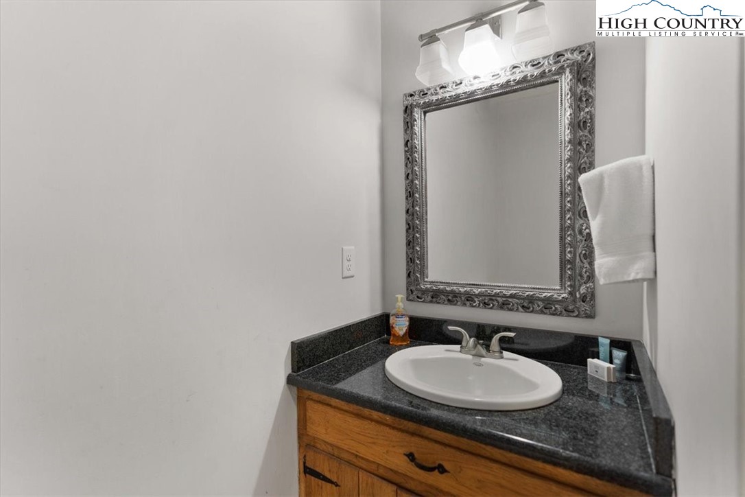 117 Chinkapin Ridge Road Seven Devils, NC 28604 - Photo 25 of 43 a bathroom with a granite countertop sink and a mirror