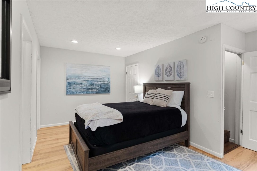 117 Chinkapin Ridge Road Seven Devils, NC 28604 - Photo 29 of 43 a bedroom with a bed and a night stand