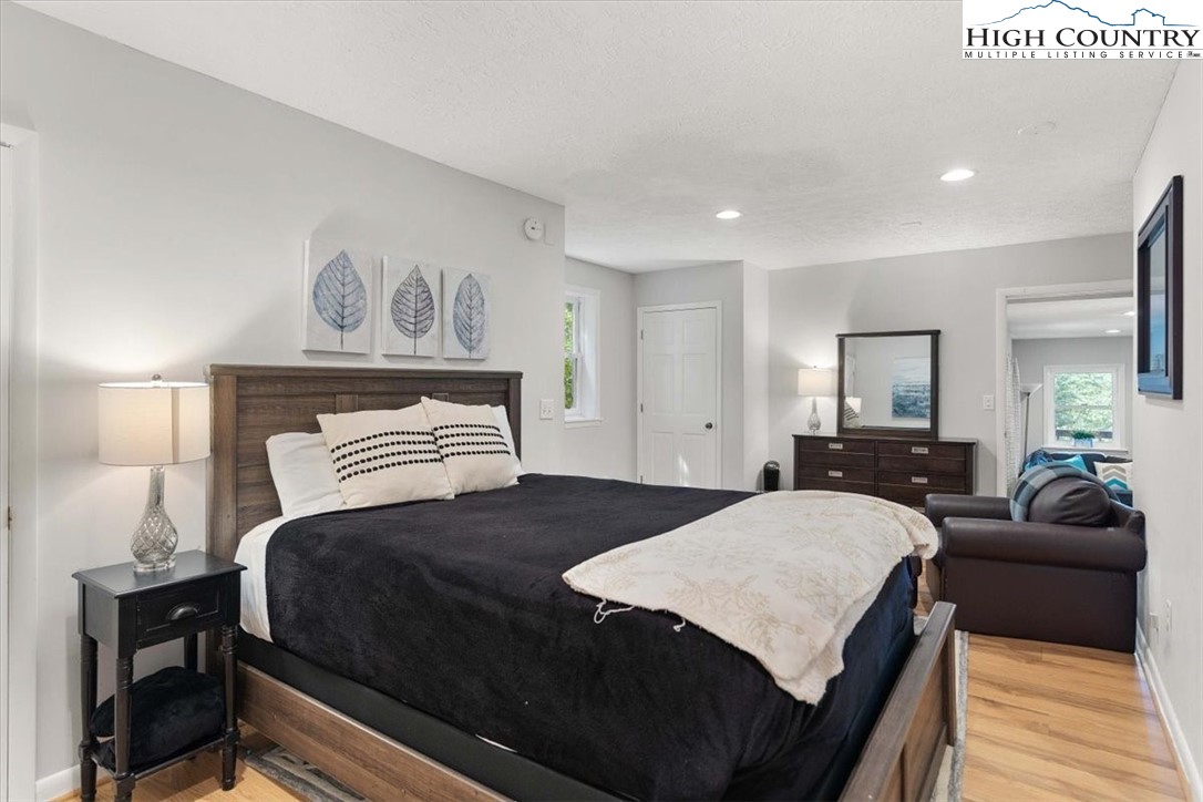 117 Chinkapin Ridge Road Seven Devils, NC 28604 - Photo 30 of 43 a bedroom with a bed and wooden floor