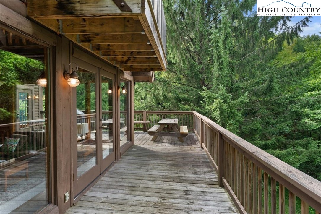 117 Chinkapin Ridge Road Seven Devils, NC 28604 - Photo 32 of 43 a balcony with wooden floor and outdoor seating