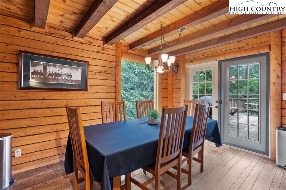 117 Chinkapin Ridge Road Seven Devils, NC 28604 - Photo 8 of 43 a view of a dining room with furniture wooden floor and a potted plant