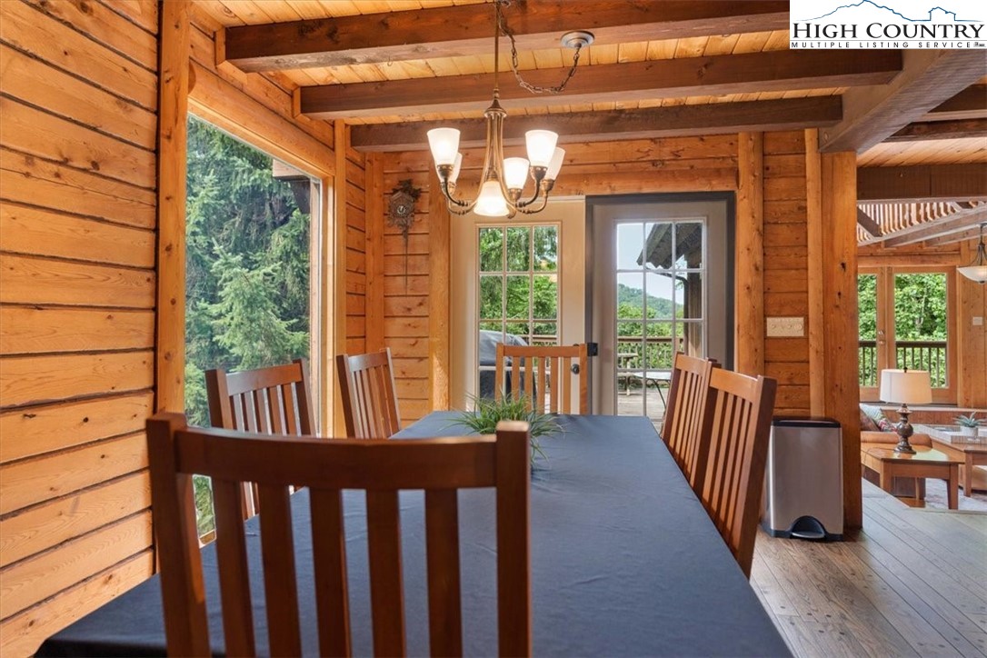 117 Chinkapin Ridge Road Seven Devils, NC 28604 - Photo 9 of 43 a view of a porch with wooden floor and furniture