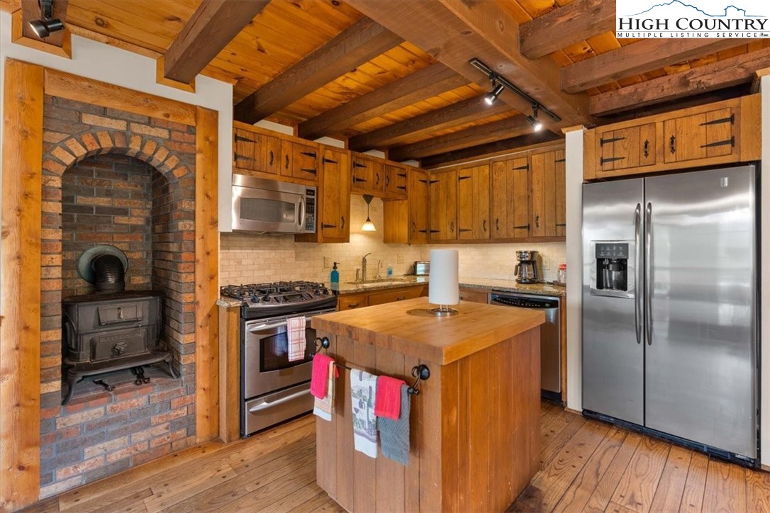 117 Chinkapin Ridge Road Seven Devils, NC 28604 - Photo 10 of 43 a kitchen with stainless steel appliances granite countertop a stove and a refrigerator
