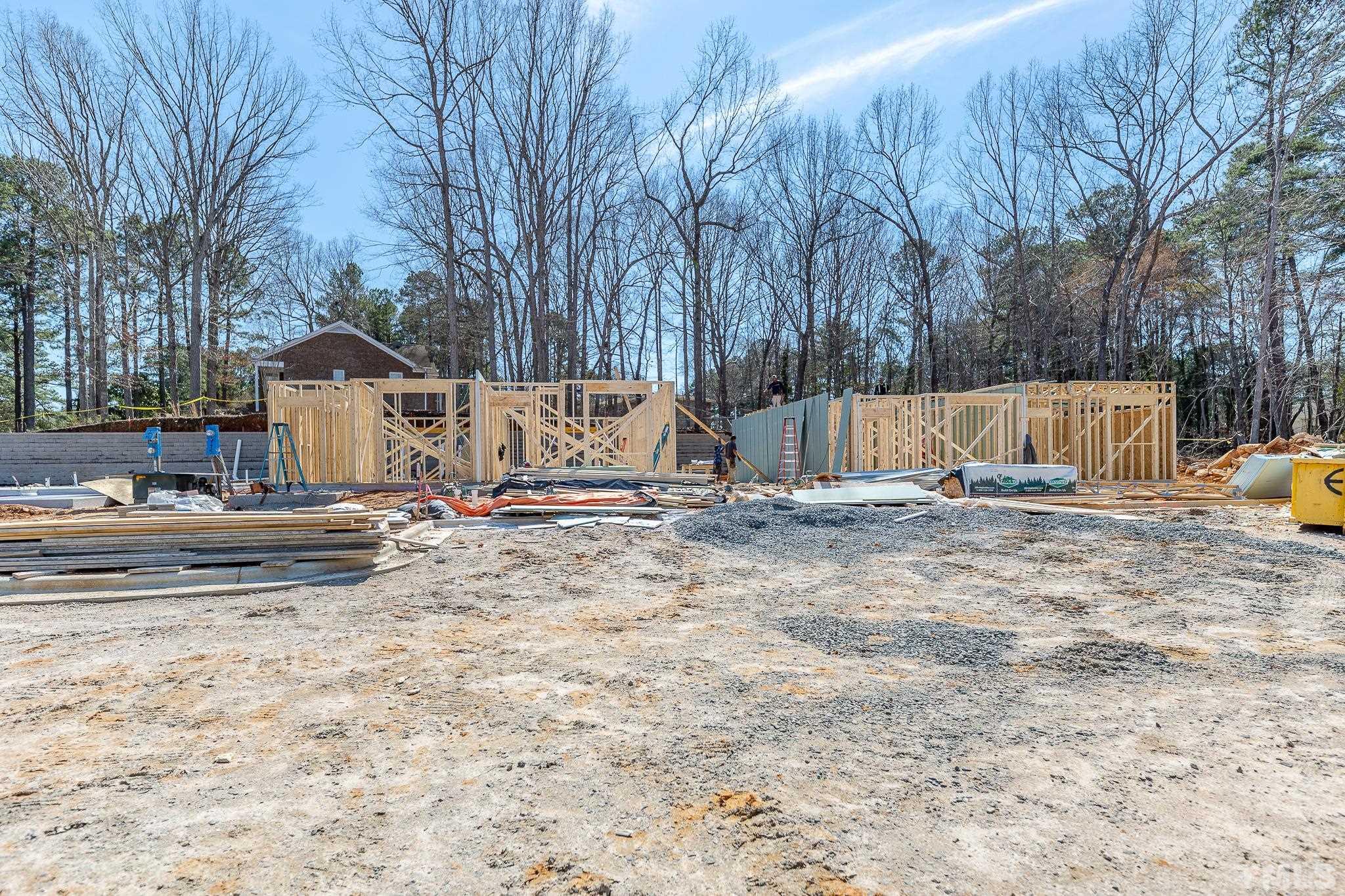 5705 Tall Pines Court Raleigh, NC 27609 - Photo 12 of 36 a view of a house with a yard covered in snow