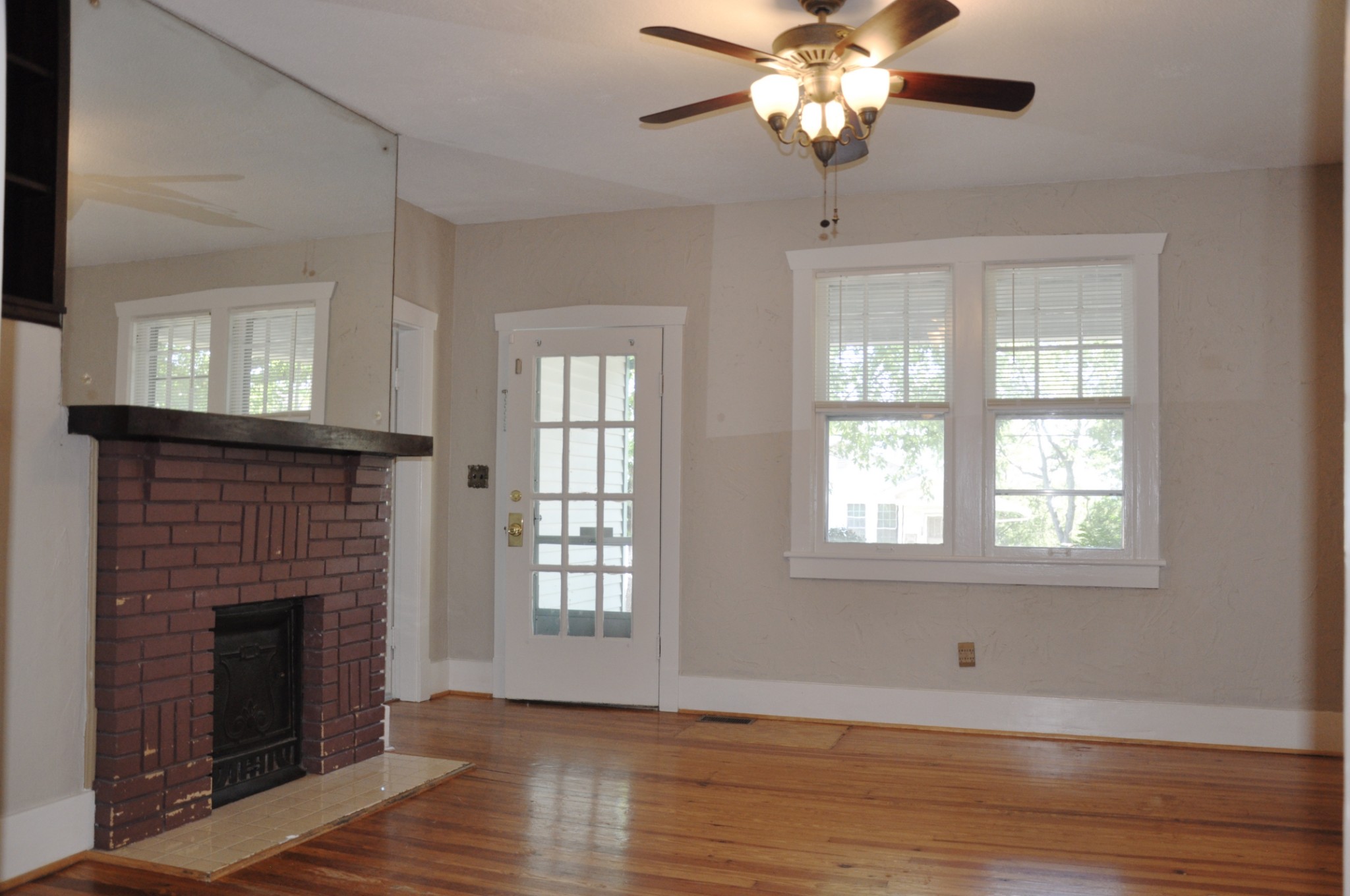 602 3rd Avenue West Springfield, TN 37172 - Photo 5 of 37 a view of an empty room with wooden floor fireplace and a window