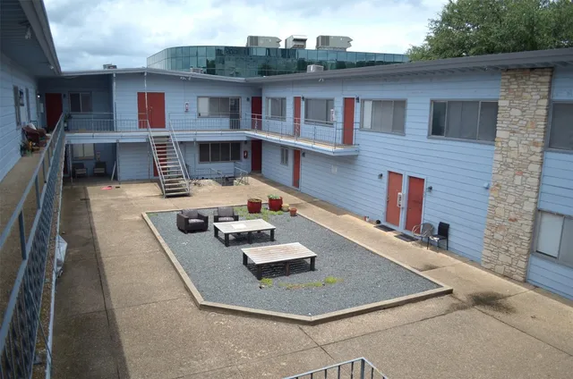 a view of a house with pool table and chairs