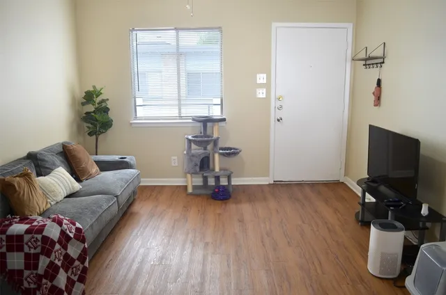 a living room with furniture and a flat screen tv