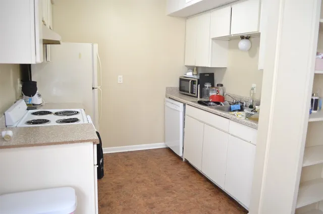 a kitchen with a sink cabinets and a stove top oven