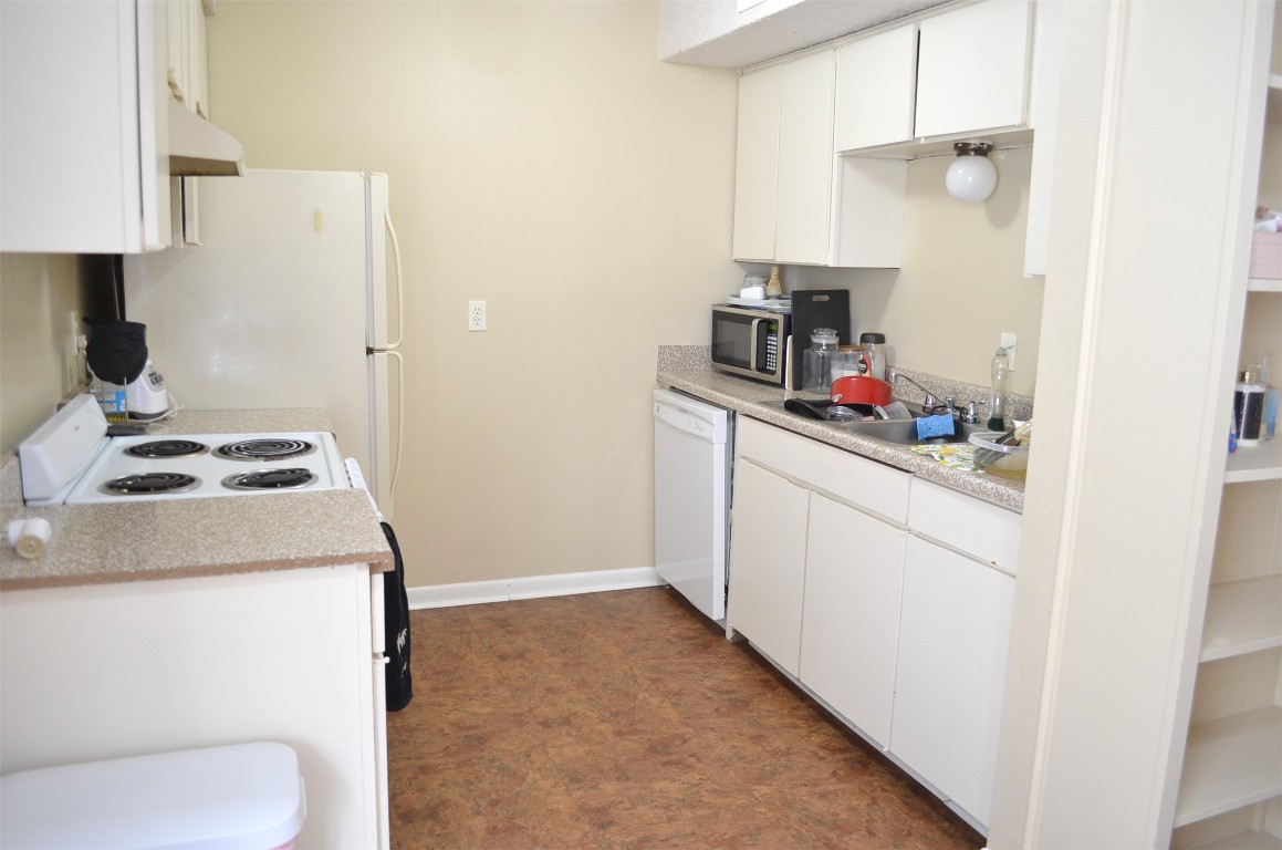 2408 Longview Street, Unit 211 Austin, TX 78705 - Photo 5 of 10 a kitchen with a sink cabinets and a stove top oven