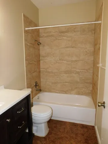 a bathroom with a toilet a sink and bathtub