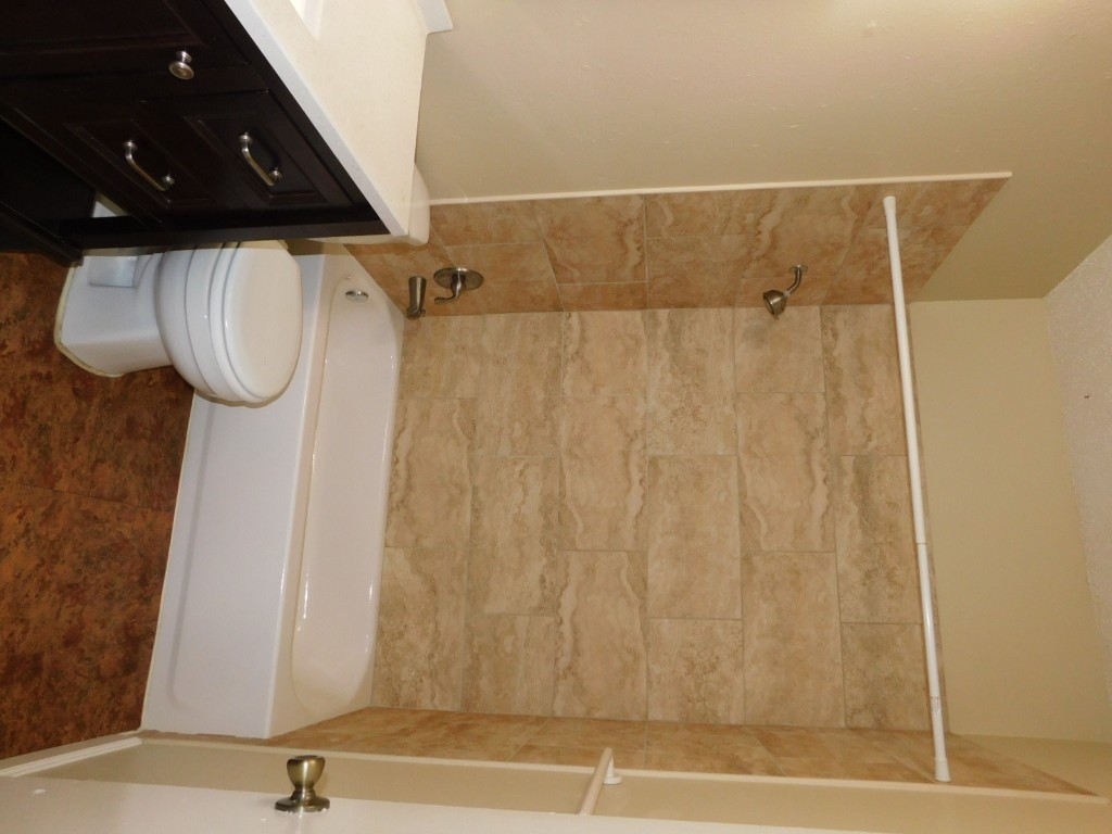 2408 Longview Street, Unit 211 Austin, TX 78705 - Photo 6 of 10 a bathroom with a toilet a sink and bathtub