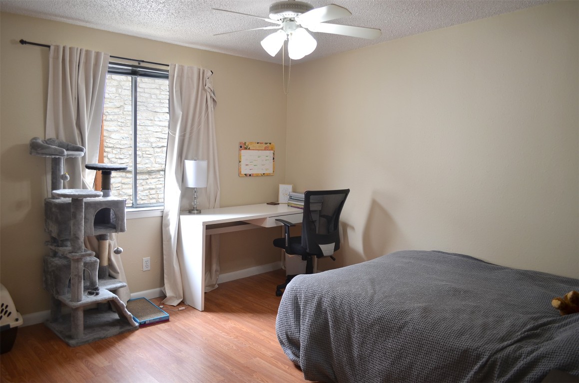 2408 Longview Street, Unit 211 Austin, TX 78705 - Photo 7 of 10 a bedroom with a bed and a window