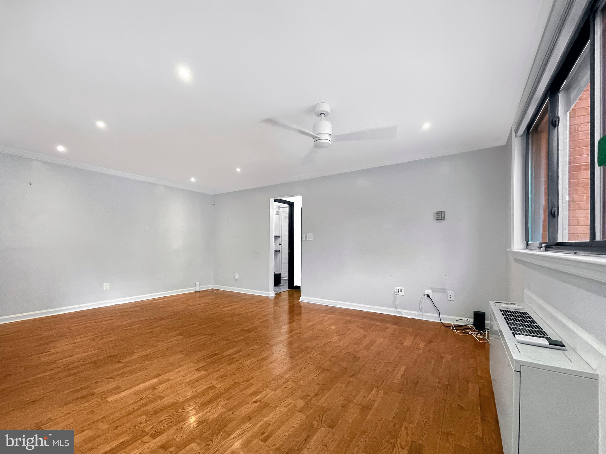 2725 39th Street Northwest, Unit 2O9 Washington, DC 20007 - Photo 11 of 35 wooden floor in an empty room with a window