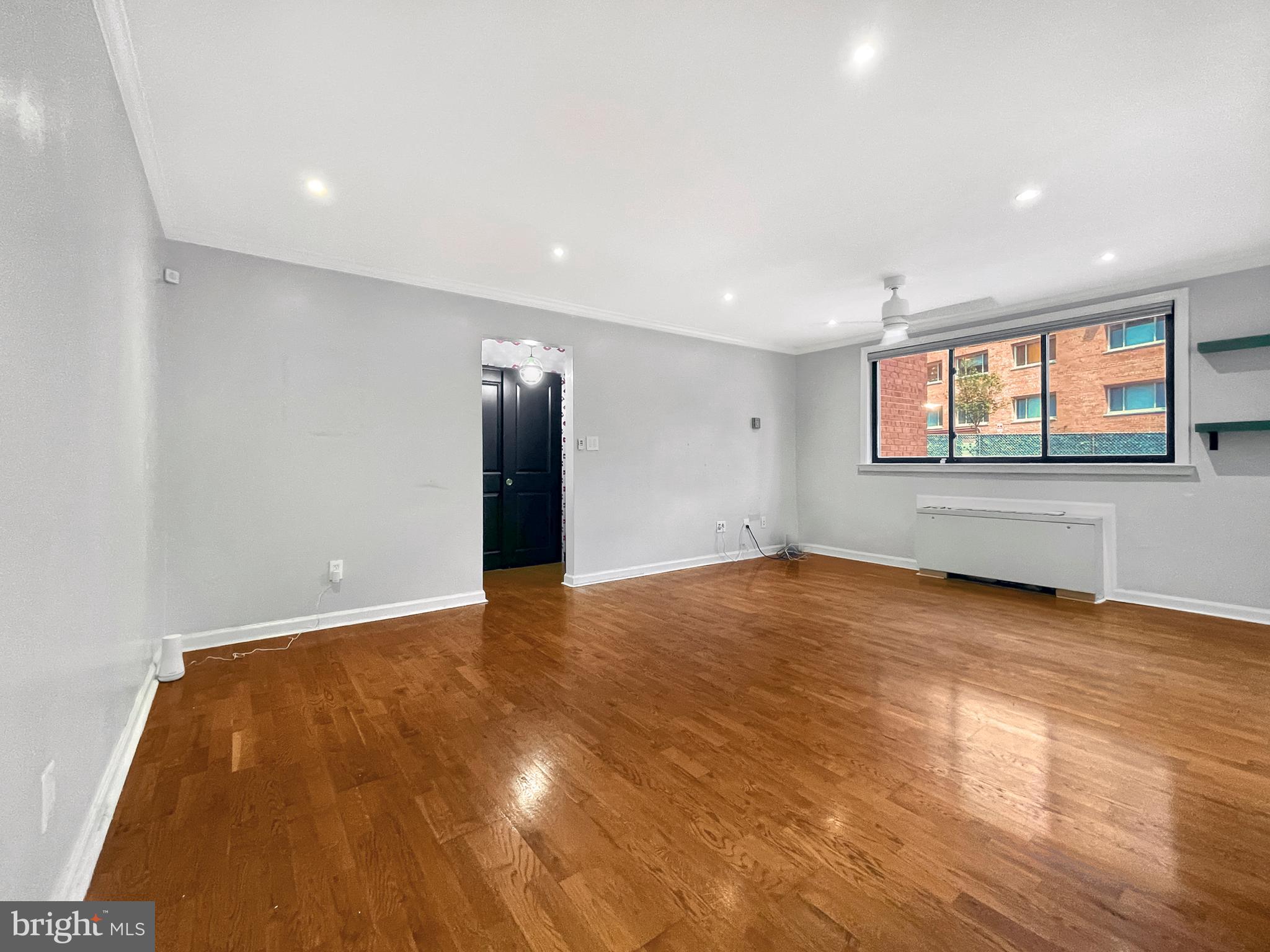 2725 39th Street Northwest, Unit 2O9 Washington, DC 20007 - Photo 12 of 35 an empty room with wooden floor and windows
