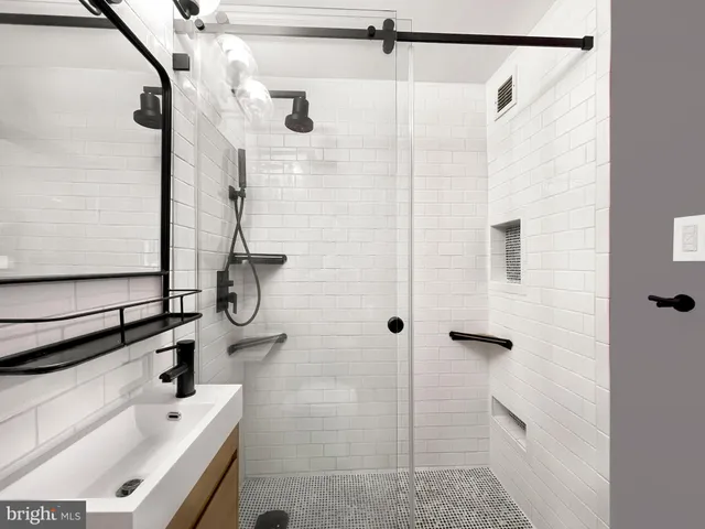a bathroom with a shower and a sink