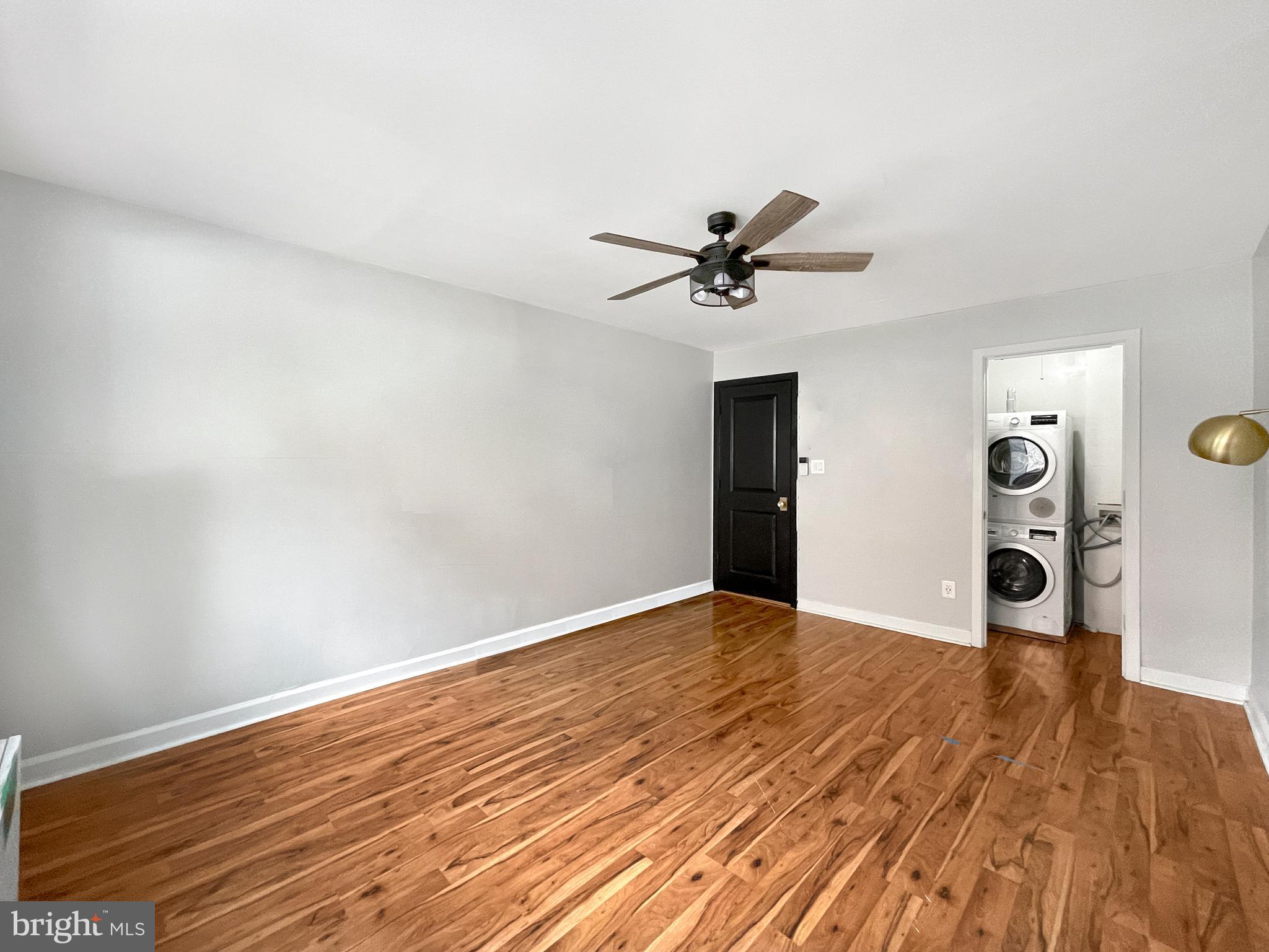 2725 39th Street Northwest, Unit 2O9 Washington, DC 20007 - Photo 17 of 35 a view of an empty room with wooden floor and a window