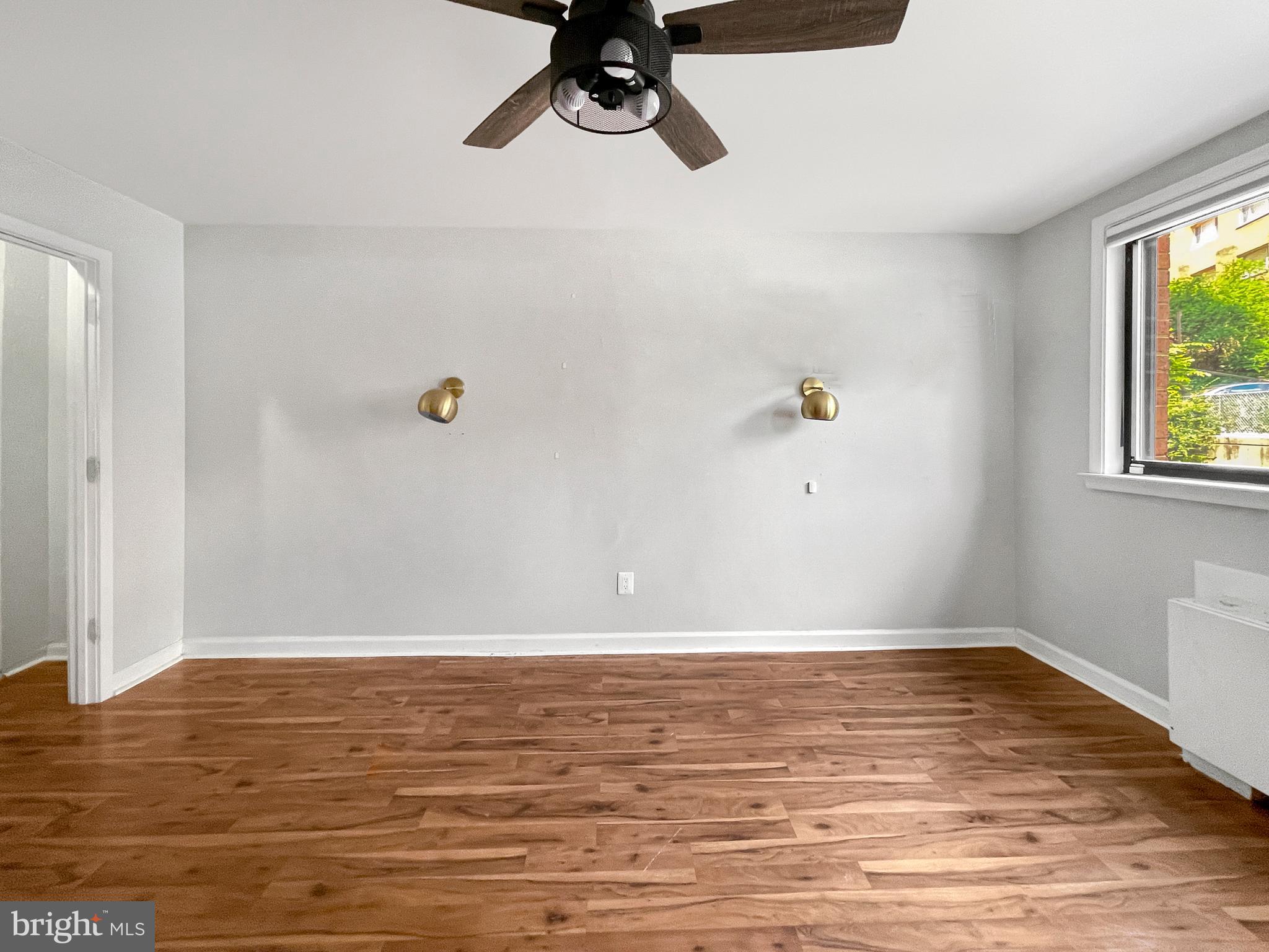 2725 39th Street Northwest, Unit 2O9 Washington, DC 20007 - Photo 18 of 35 a view of a room with wooden floor and window