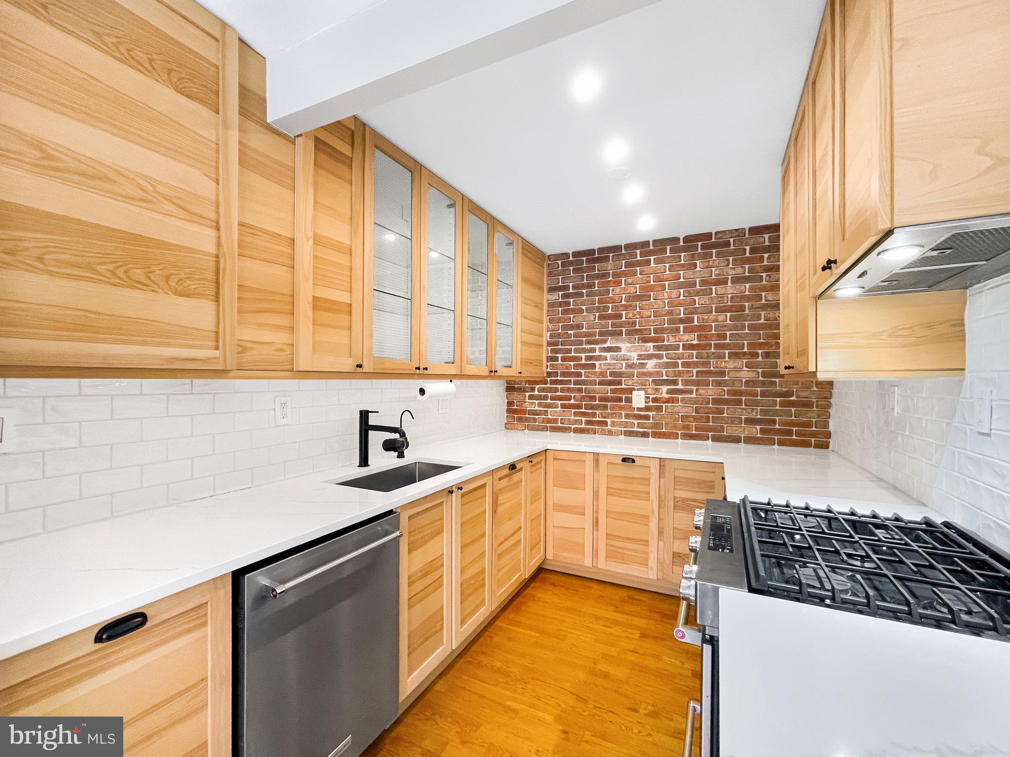 2725 39th Street Northwest, Unit 2O9 Washington, DC 20007 - Photo 2 of 35 a kitchen with stainless steel appliances a sink stove and cabinets