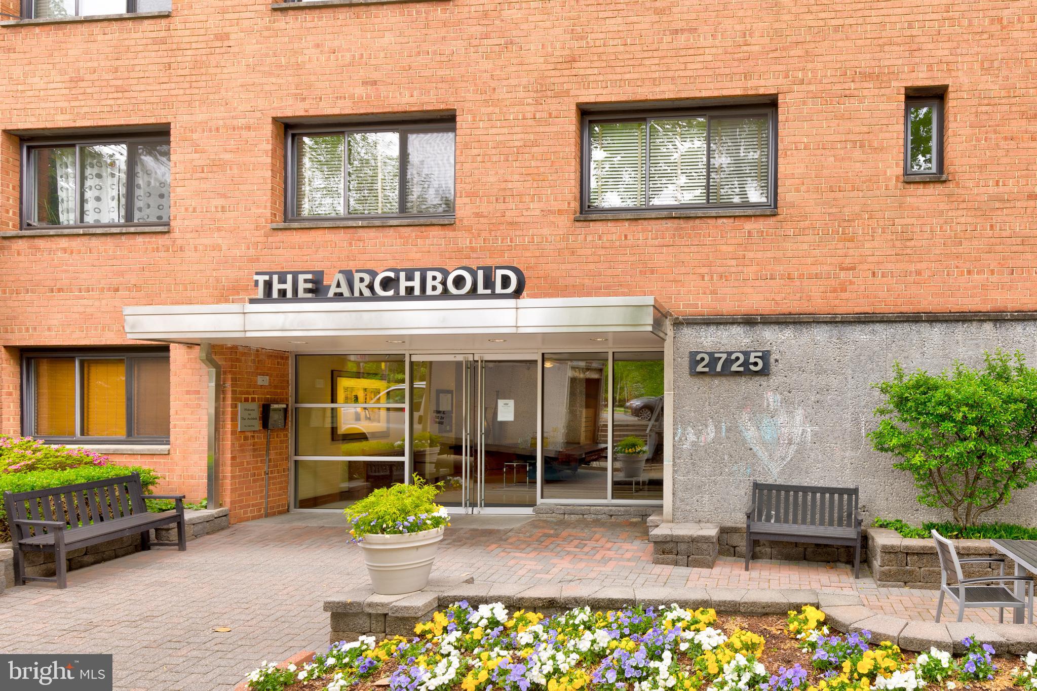2725 39th Street Northwest, Unit 2O9 Washington, DC 20007 - Photo 21 of 35 front view of a brick building with a bench in front of building