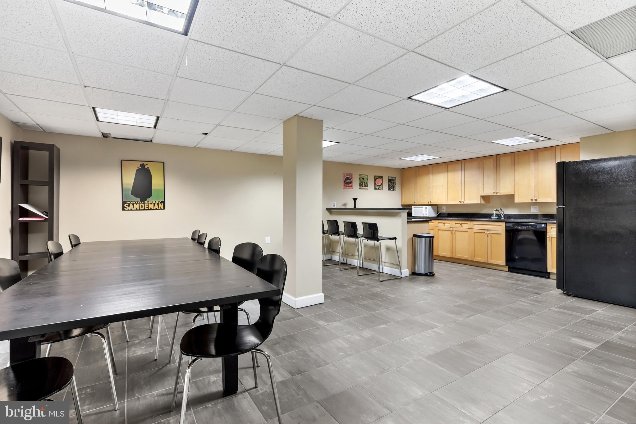 2725 39th Street Northwest, Unit 2O9 Washington, DC 20007 - Photo 24 of 35 a kitchen with stainless steel appliances kitchen island granite countertop a sink a stove a refrigerator a counter top space and cabinets