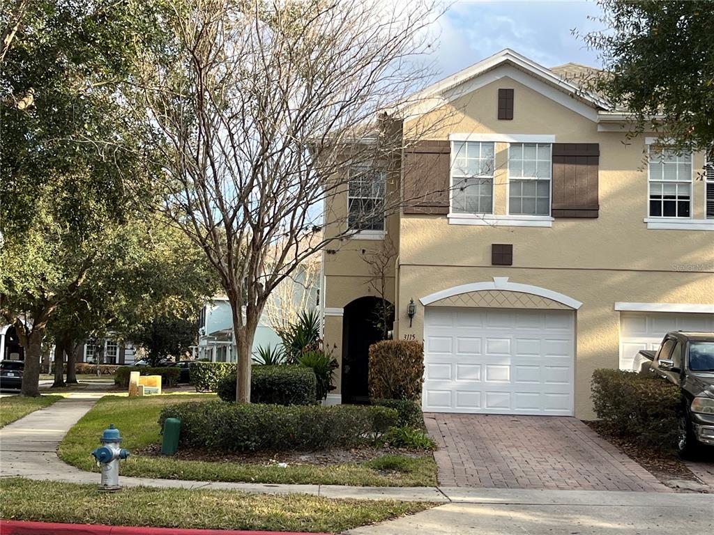 3115 Capri Isle Way Orlando, FL 32835 - Photo 1 of 40 a front view of a house with garden