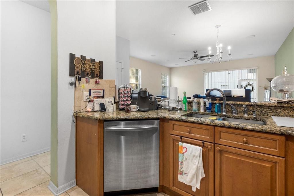 3115 Capri Isle Way Orlando, FL 32835 - Photo 16 of 40 a kitchen with stainless steel appliances granite countertop a sink and cabinets