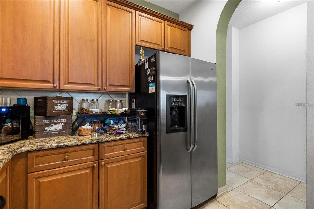3115 Capri Isle Way Orlando, FL 32835 - Photo 17 of 40 a kitchen with stainless steel appliances granite countertop a refrigerator and a stove top oven