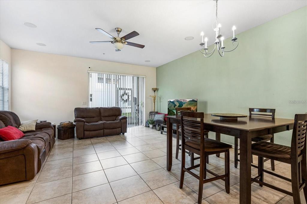 3115 Capri Isle Way Orlando, FL 32835 - Photo 19 of 40 a living room with furniture and a chandelier