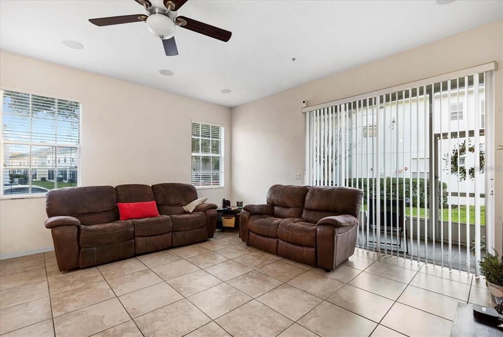 3115 Capri Isle Way Orlando, FL 32835 - Photo 21 of 40 a living room with furniture and a window