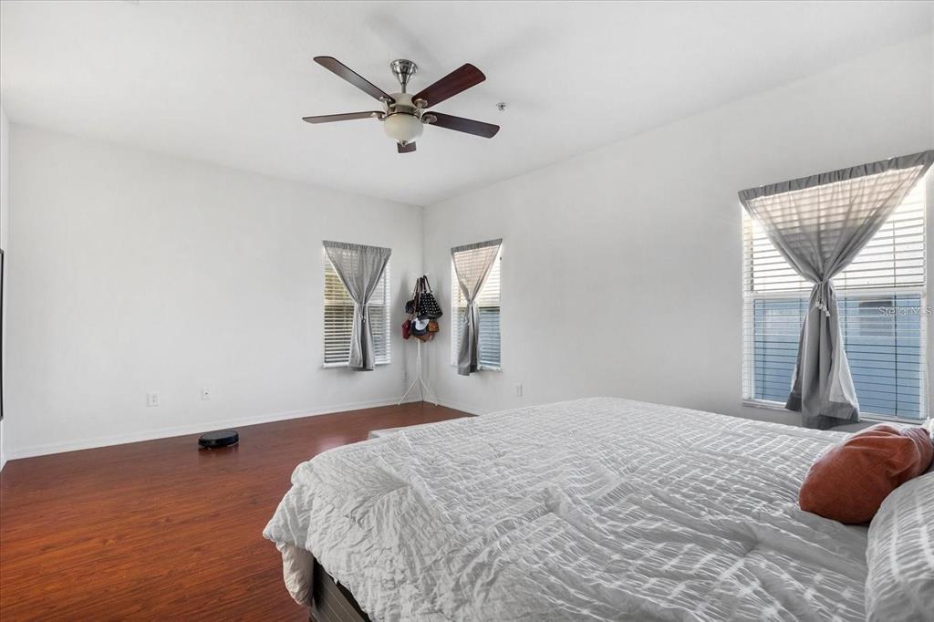 3115 Capri Isle Way Orlando, FL 32835 - Photo 25 of 40 a bedroom with a large bed and a window