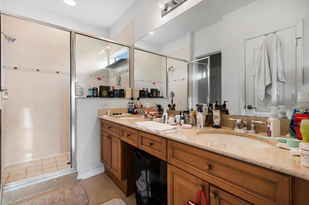 3115 Capri Isle Way Orlando, FL 32835 - Photo 26 of 40 a bathroom with a double vanity sink mirror and double