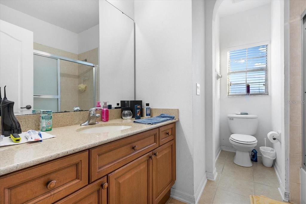 3115 Capri Isle Way Orlando, FL 32835 - Photo 28 of 40 a bathroom with a sink and a mirror