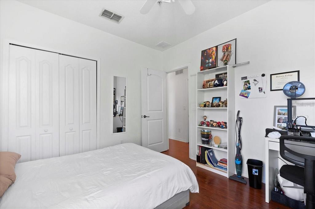 3115 Capri Isle Way Orlando, FL 32835 - Photo 31 of 40 a bedroom with a bed and a book shelf