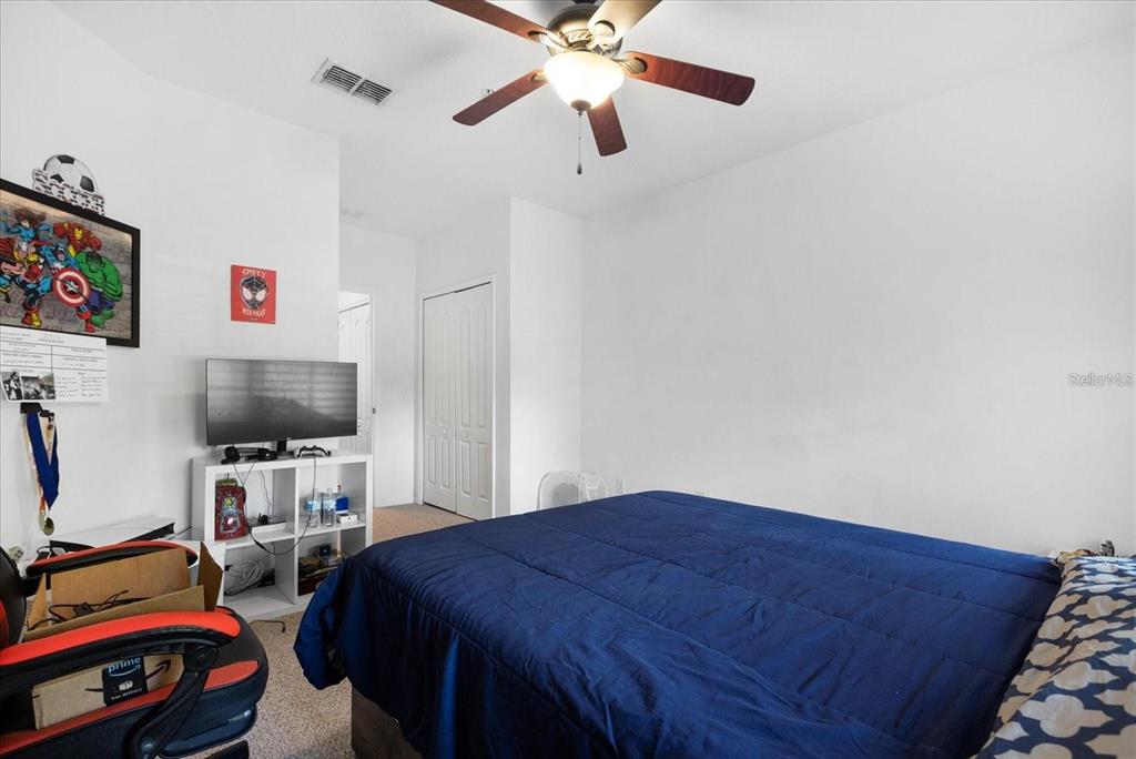 3115 Capri Isle Way Orlando, FL 32835 - Photo 33 of 40 a bedroom with bed and a tv