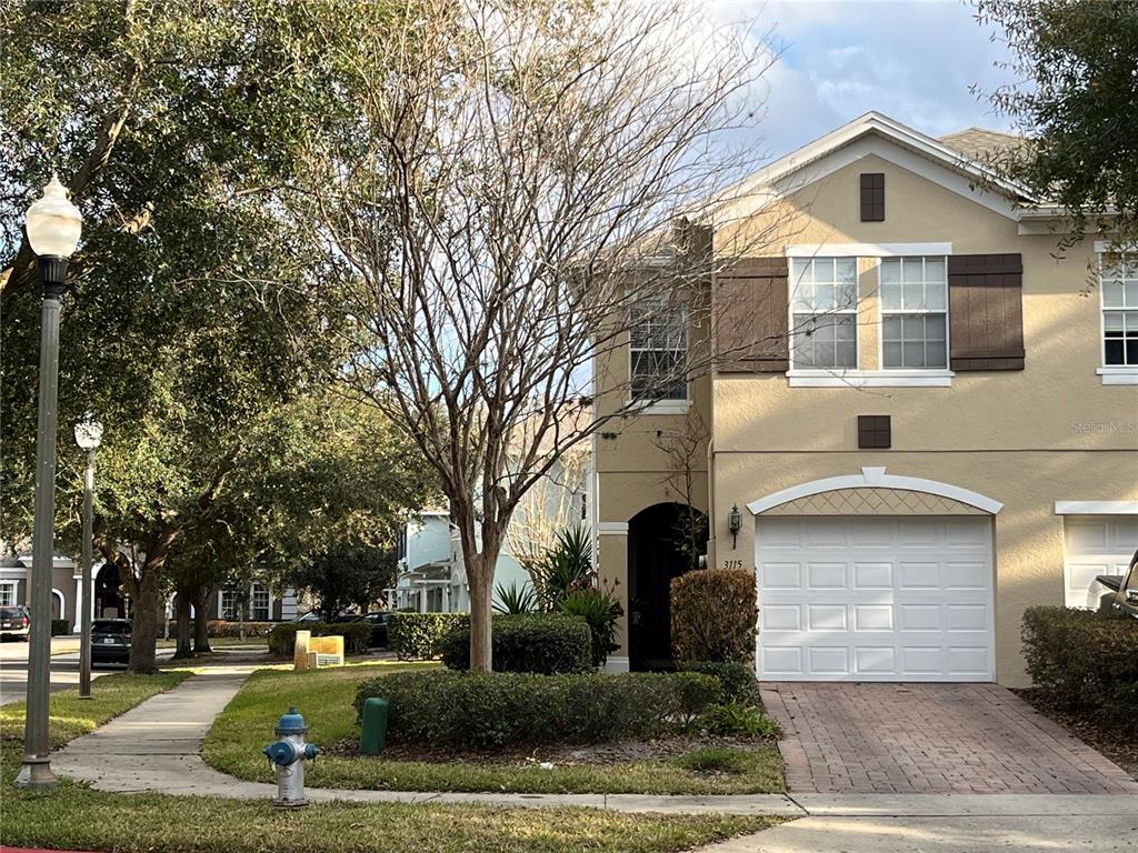 3115 Capri Isle Way Orlando, FL 32835 - Photo 4 of 40 a front view of a house with a yard
