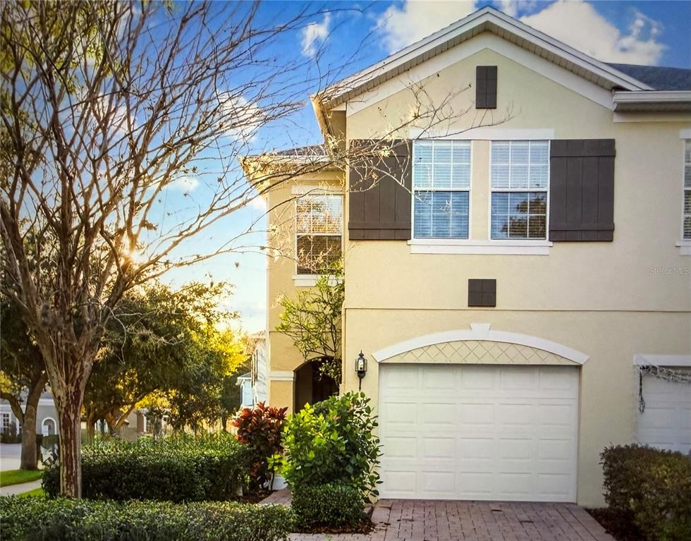3115 Capri Isle Way Orlando, FL 32835 - Photo 5 of 40 a front view of a house with a garden