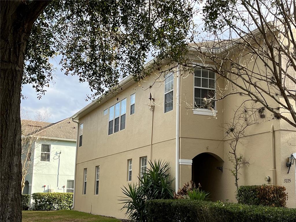 3115 Capri Isle Way Orlando, FL 32835 - Photo 7 of 40 a white building with a large tree