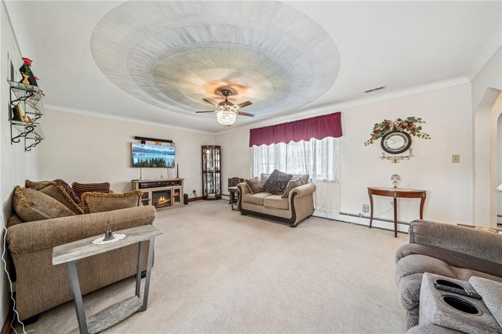 974 Renton Road Pittsburgh, PA 15239 - Photo 13 of 48 a living room with furniture and a chandelier