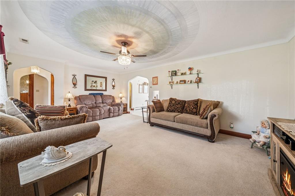 974 Renton Road Pittsburgh, PA 15239 - Photo 16 of 48 a living room with furniture and a chandelier