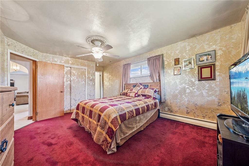 974 Renton Road Pittsburgh, PA 15239 - Photo 21 of 48 a bedroom with a bed and a flat screen tv