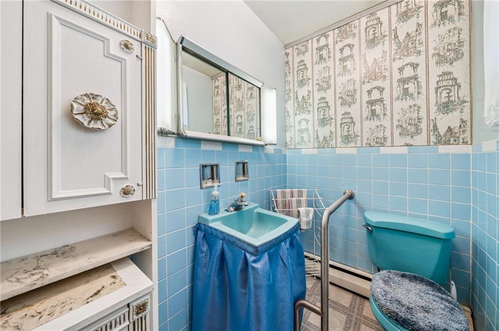 974 Renton Road Pittsburgh, PA 15239 - Photo 22 of 48 a bathroom with a sink a toilet and a mirror