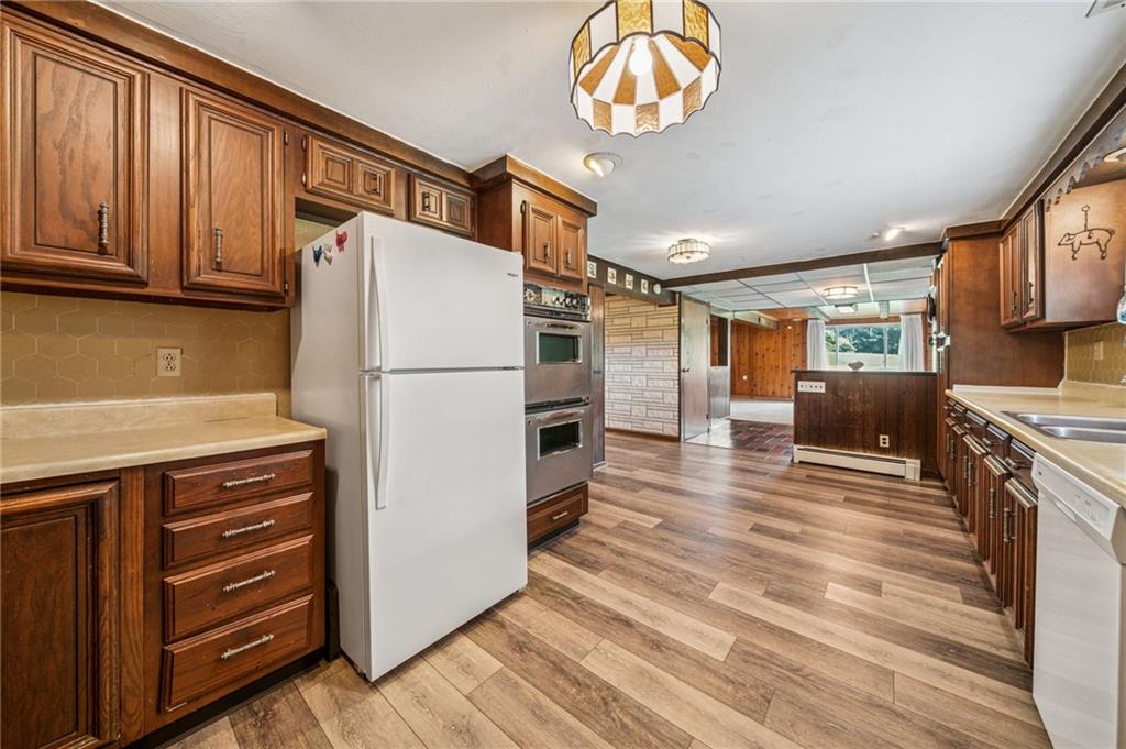 974 Renton Road Pittsburgh, PA 15239 - Photo 29 of 48 a kitchen with stainless steel appliances granite countertop a refrigerator a stove and a sink with cabinets