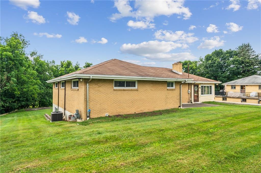 974 Renton Road Pittsburgh, PA 15239 - Photo 47 of 48 a front view of a house with a garden