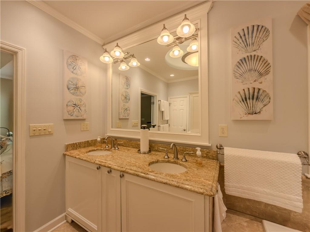 4284 Cedar Bluff Way Southwest Lilburn, GA 30047 - Photo 15 of 62 a bathroom with a sink vanity granite tub and a mirror