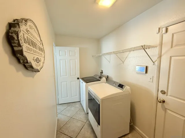 a utility room with a sink and a mirror